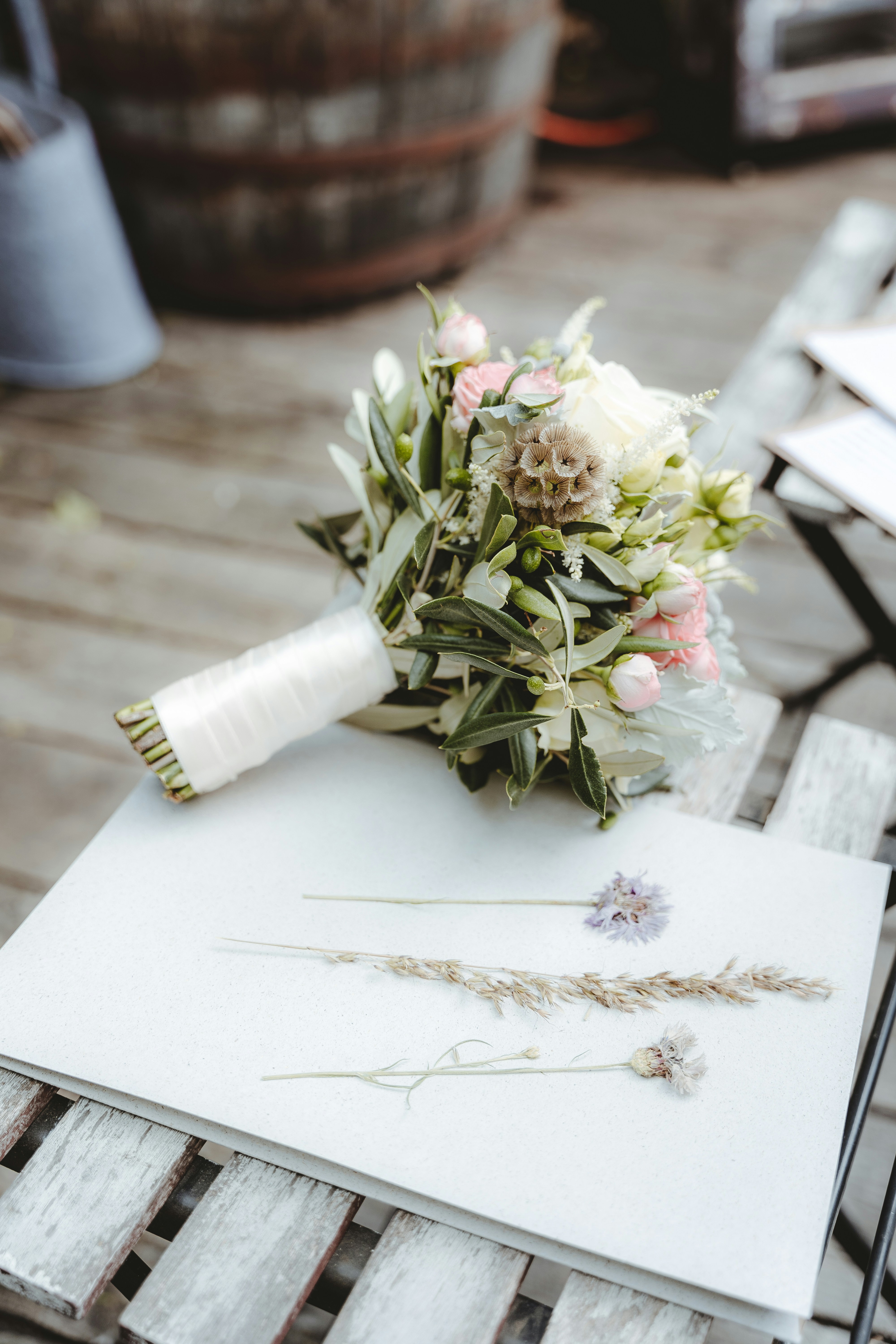 Judith Fick hand-arranging a vibrant seasonal floral bouquet at Jude's Blooms